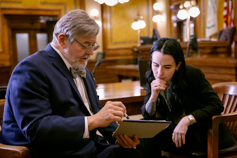 Attorneys Robert A. Schembs and Brooke N. McMillin discussing trial strategy